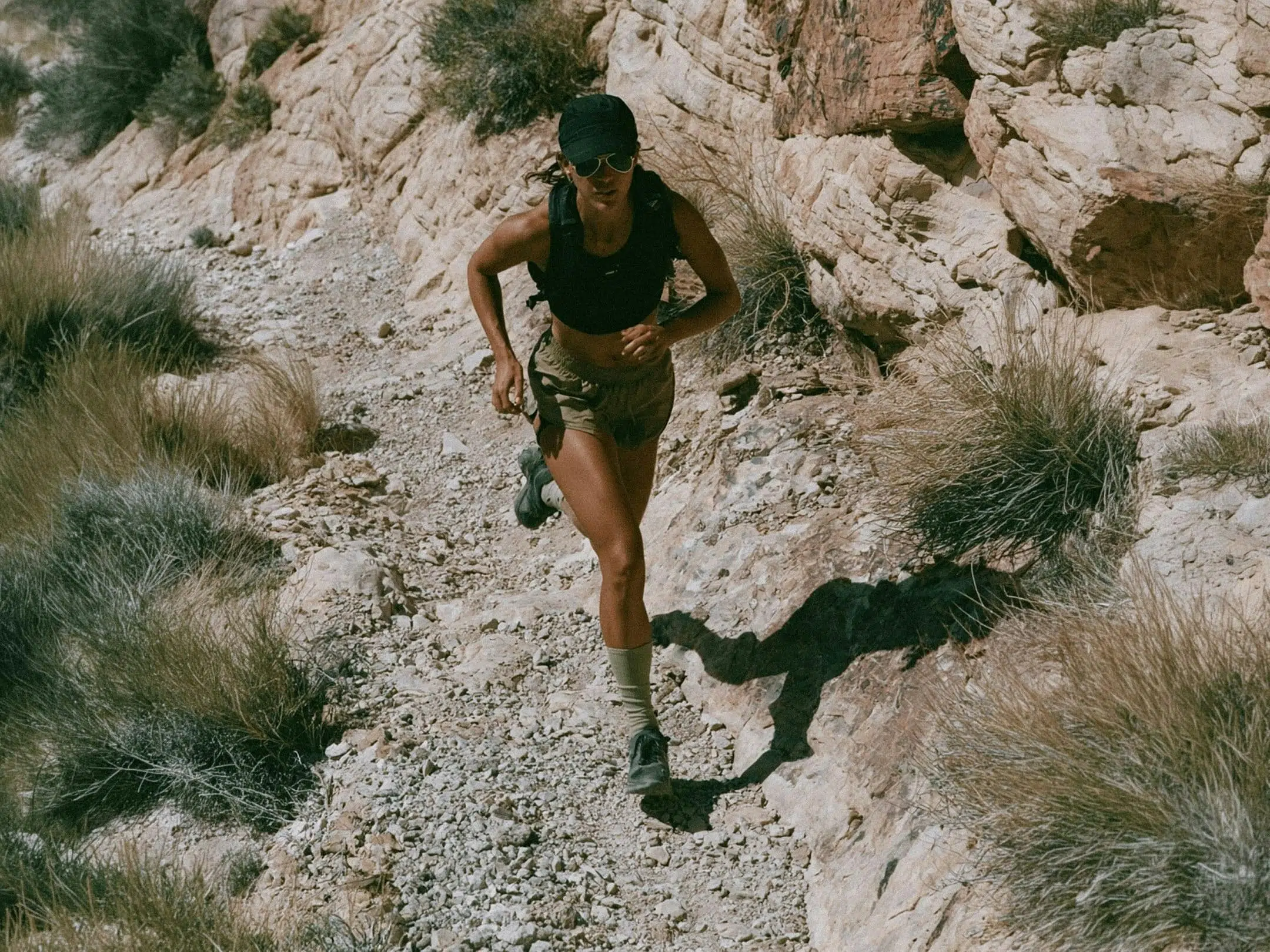 Trail runner on a rocky mountain path